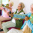 Group of older adult women stretching with exercise bands