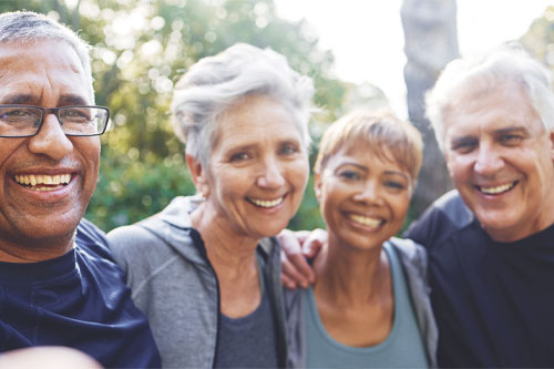 Group of older adults laughing and smiling outside