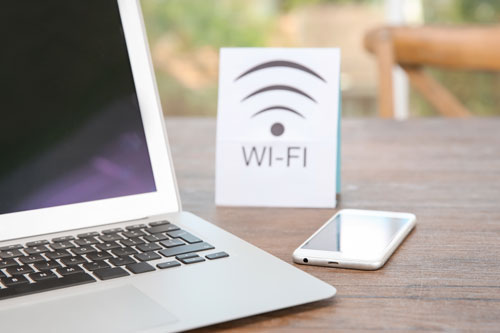 Image of a computer, phone, and wifi sign