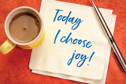 Today I choose joy positive affirmation written on a napkin next to a cup of coffee