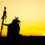 The Indians are riding a horse and spear ready to use In light o