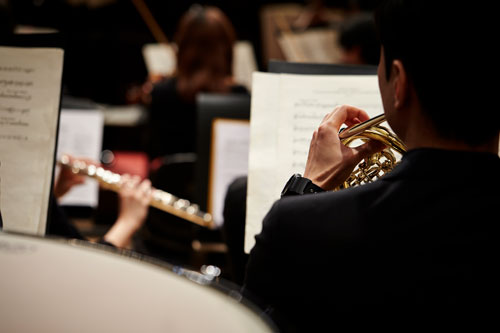 man playing a trumpet in a band