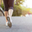 Close-up of a woman's shoes walking on pavement in bright daylight