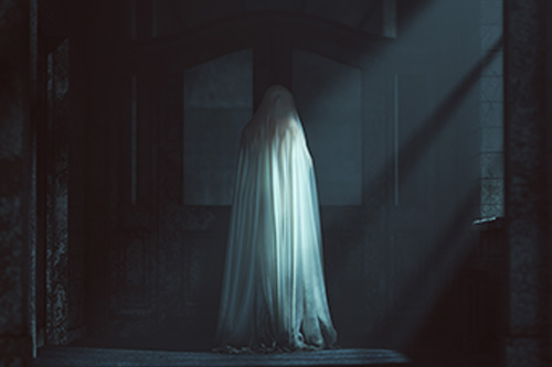 Eerie ghostly figure standing in the shadows of a dimly lit room