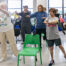 group of elderly people in room with hands up in air during a class