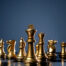 Gold chess pieces on board