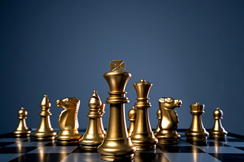 Gold chess pieces on board