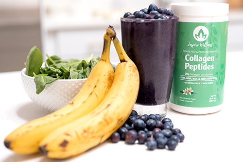 smoothie on counter with collagen container and bananas