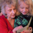 Rebecca Massie, Oasis instructor, and her grandson look at a card