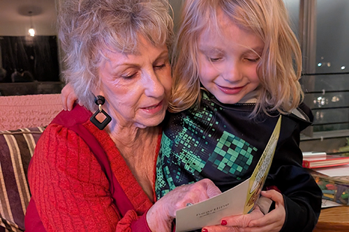Rebecca Massie, Oasis instructor, and her grandson look at a card